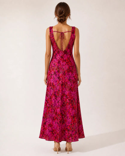 Women's pink floral sleeveless cowl-neck bias-cut maxi dress, open-back view.