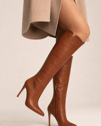 Brown leather knee-high boots showing the slim heel and discreet inner zip.