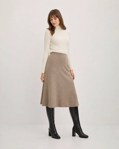 Women's black knee-high broad-heel boots with midi-skirt styling.