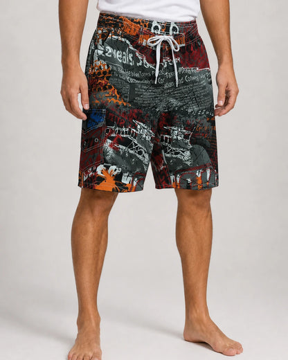 Dark red and orange graphic knee-length swim shorts, front view.
